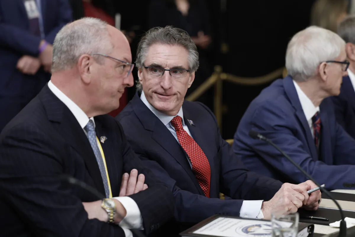 Louisiana Gov. John Bel Edwards (L) speaks with North Dakota Gov. Doug Burgum (C) before the start of a meeting between U.S. President Joe Biden and governors visiting from states around the country, in the East Room of the White House in Washington on Feb. 10, 2023. (Anna Moneymaker/Getty Images)