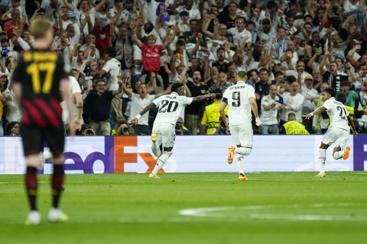 Real Madrid's Vinicius Junior, center, celebrates after scoring his side's opening goal during the Champions League semifinal first leg soccer match between Real Madrid and Manchester City at the Santiago Bernabeu stadium in Madrid, Spain, on May 9, 2023. (Jose Breton/AP Photo)