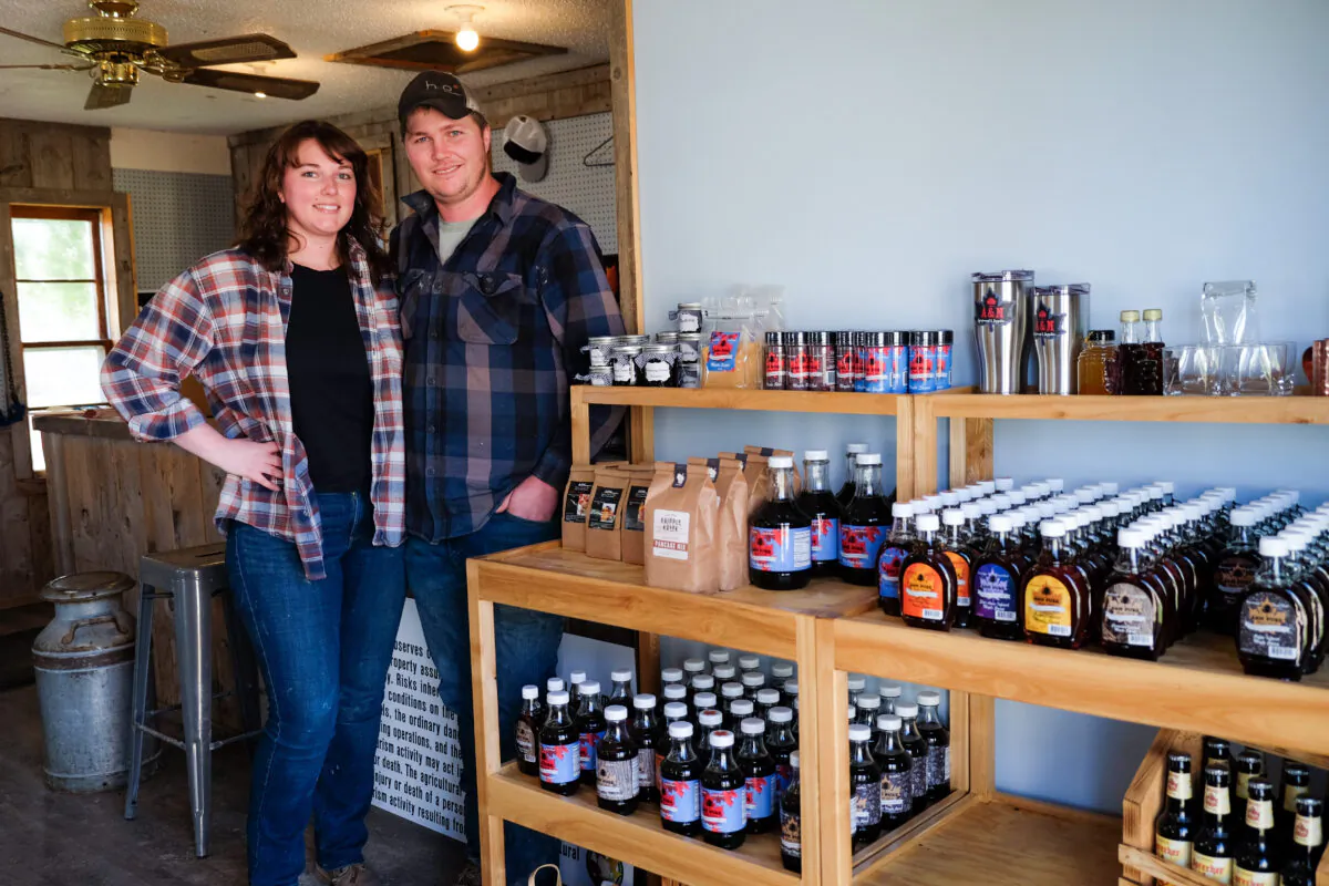 Andy and Marylin Humphrey stand by some of their maple syrup products in their soon-to-be-outgrown supply store, a converted tack shop. (Annie Holmquist)