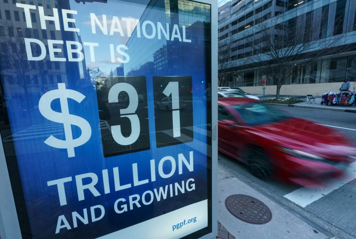 A sign at a bus shelter shows the national debt in Washington, D.C., on Jan. 20, 2023. (Mandel Ngan/AFP via Getty Images)