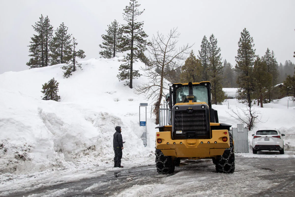 Matt Daniels, owner of Tahoe Marine and Excavating, has helped create a hill of discarded snow plowed from parking lots in Tahoe City, California, on March 10, 2023. (Karl Mondon/Bay Area News Group/TNS)