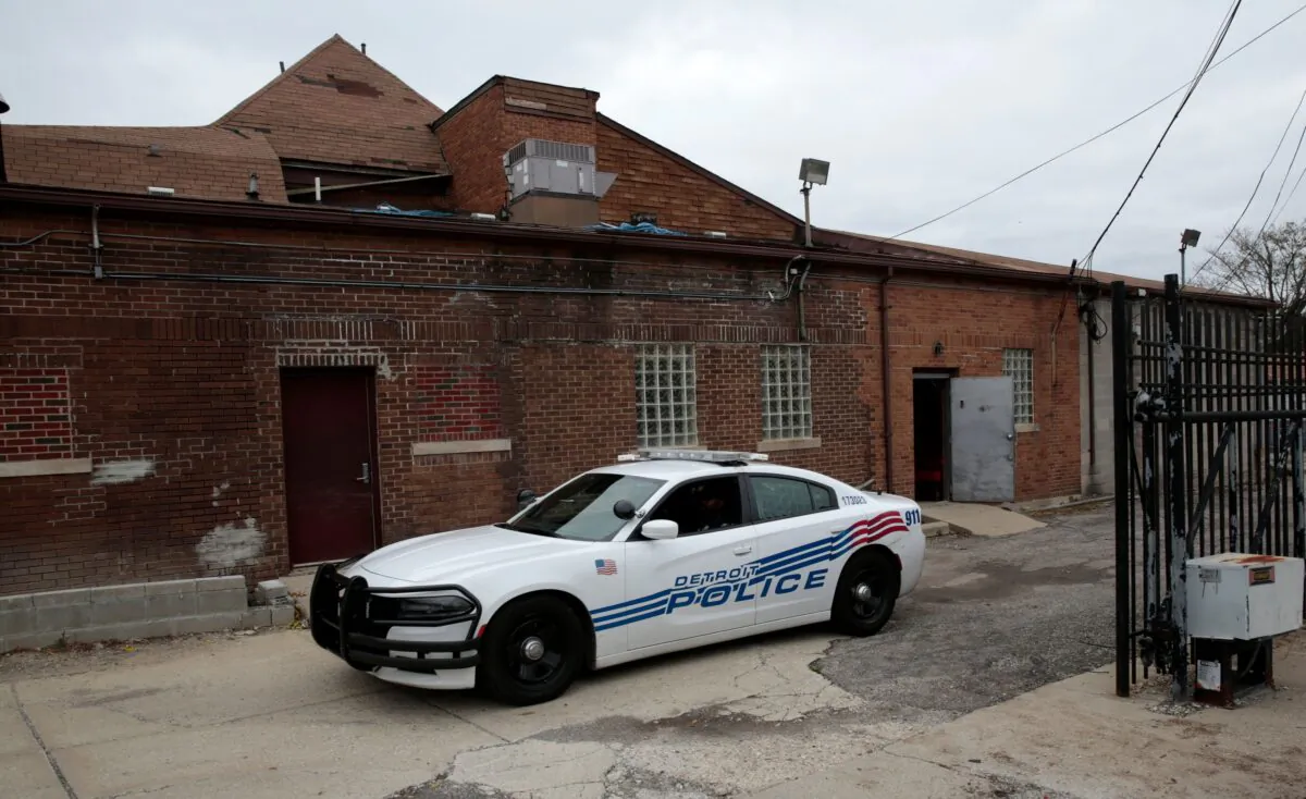Detroit Police drive down the ally of the closed Cantrell Funeral Home on Mack Avenue in Detroit on Oct. 21, 2018. (Jeff Kowalsky/AFP via Getty Images)