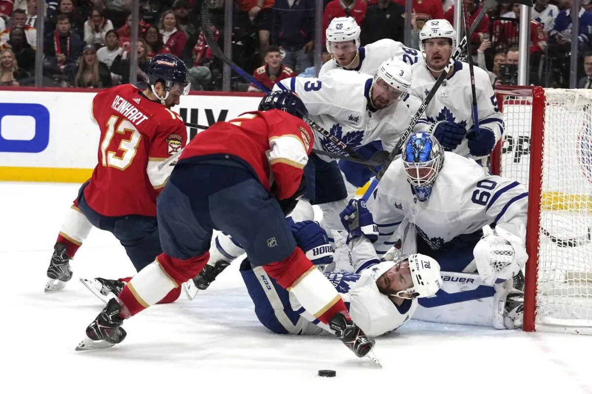 Toronto Maple Leafs goaltender Joseph Woll (60) watches the puck as defenseman TJ Brodie falls to the ice during the second period of Game 4 of the team's NHL hockey Stanley Cup second-round playoff series against the Florida Panthers on May 10, 2023, in Sunrise, Fla. (AP Photo/Lynne Sladky)