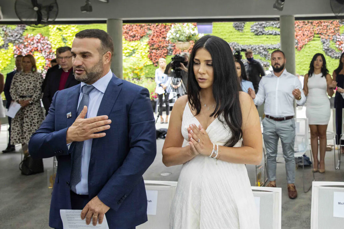 Leila and Danny Abdallah pray during the launch of i4give Day at The Calyx, Royal Botanic Gardens in Sydney, Australia, on Jan. 31, 2021. (AAP Image/Jenny Evans)