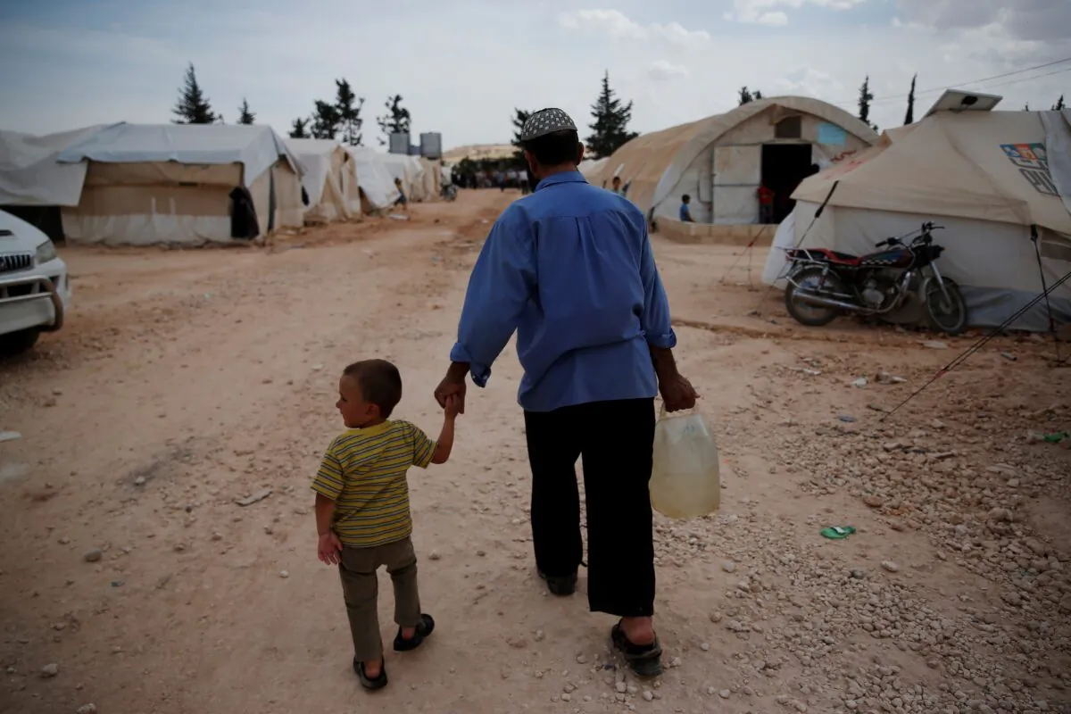 Syrians walk in a camp for internally displaced people in al-Bab, northern Syria, on May 29, 2018. (Lefteris Pitarakis/AP Photo)