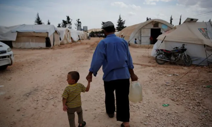 Syrians walk in a camp for internally displaced people in al-Bab, northern Syria, on May 29, 2018. (Lefteris Pitarakis/AP Photo)