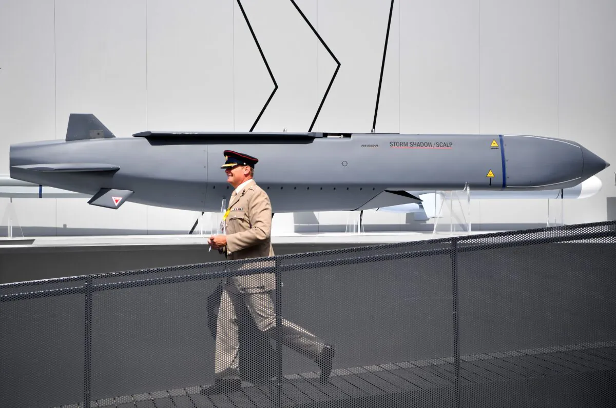 A member of the military walks past a MBDA Storm Shadow/Scalp missile at the Farnborough Airshow, southwest of London, on July 17, 2018. (Ben Stansall/AFP via Getty Images)