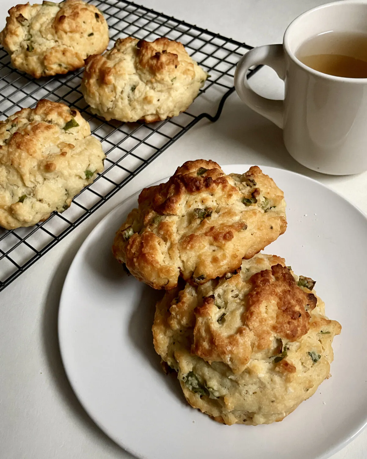 Speckled with bits of scallions, this tender cream cheese scone has a sharp, somewhat peppery allium bite that’s perfect at tea time. (Stephanie Loo/TNS)