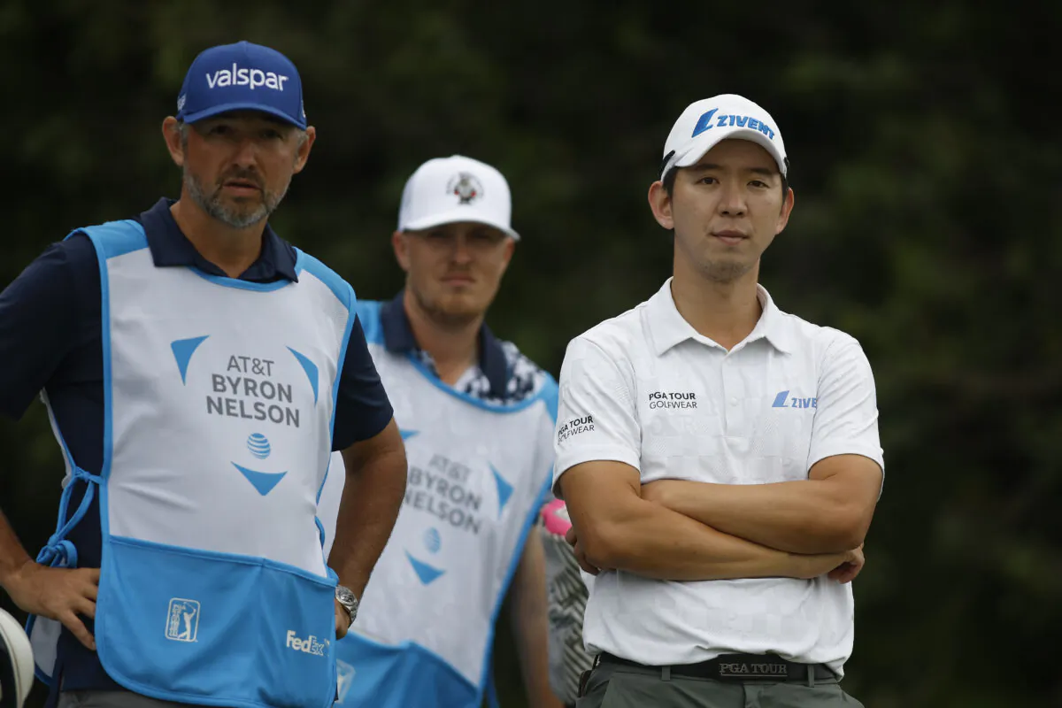 Seung Yul Noh of South Korea stands on the 16th tee alongside two caddies during the first round of the AT&T Byron Nelson at TPC Craig Ranch in McKinney, Texas, on May 11, 2023. (Tim Heitman/Getty Images)