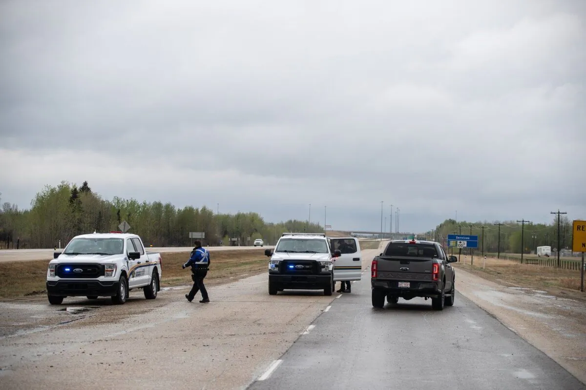 Police block the road into the wildfires near Entwhistle Alberta on May 7, 2023. (The Canadian Press/Jason Franson)