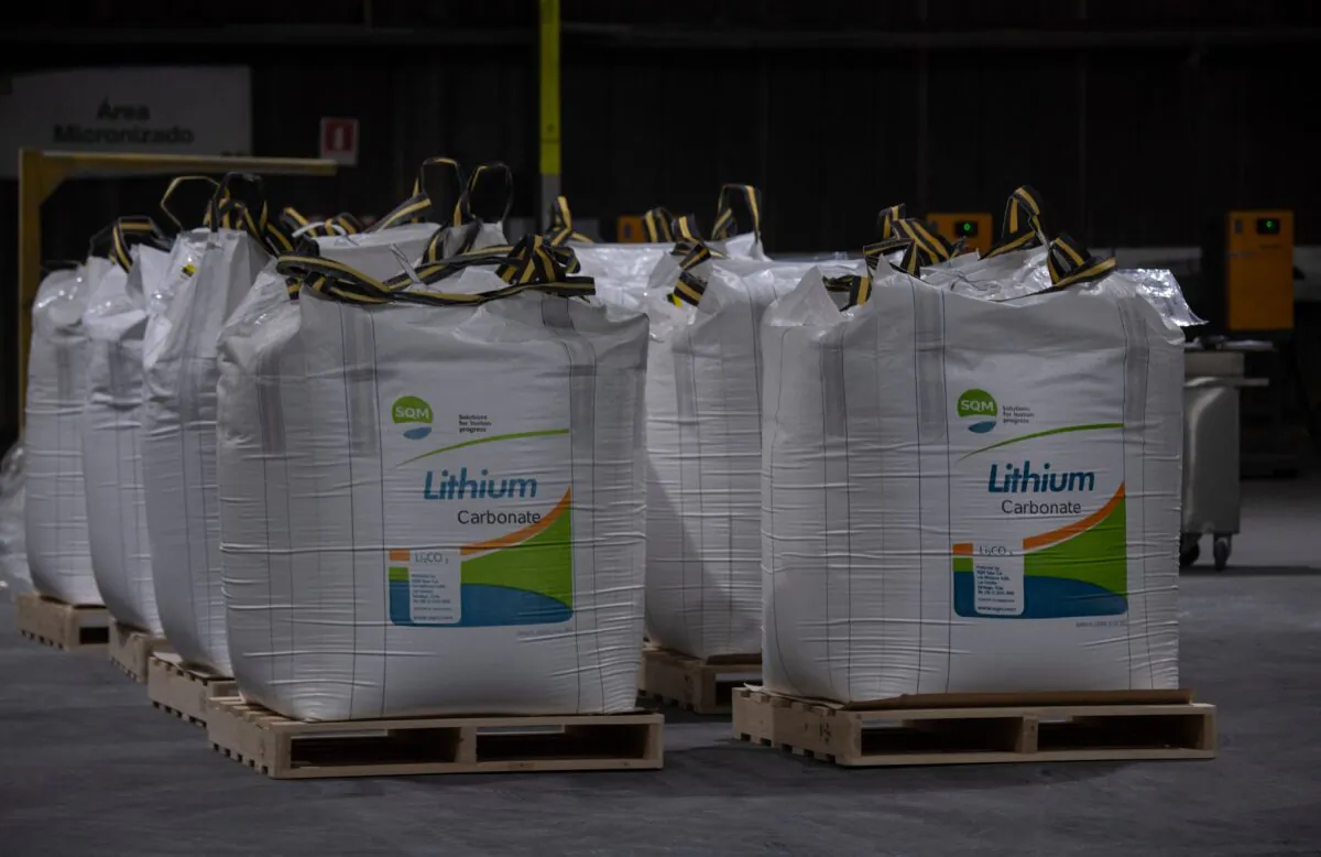 Workers walk past 500-kilogram bags of lithium being stored at the El Carmen lithium processing plant in Antofagasta, Chile, on Sept.13, 2022. (Martin Bernetti/AFP via Getty Images)