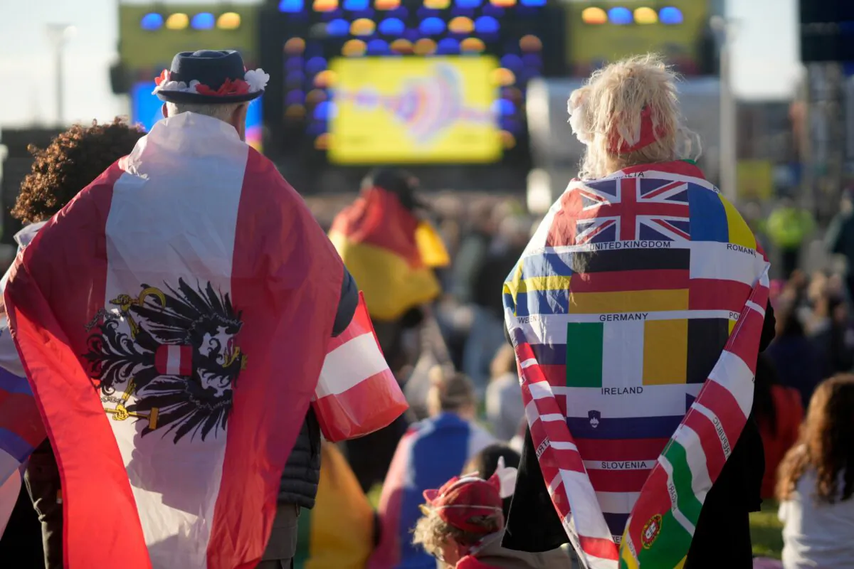 Music fans dance and watch the Eurovision Song Contest Semi-Final 2 on a giant screen in the Eurovision Village on the riverside in Liverpool, England, on May 11, 2023. (Christopher Furlong/Getty Images)