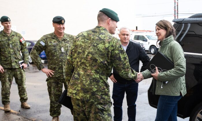 Alberta Premier Danielle Smith meets with members of the military in Edmonton who are on stand-by to help with the wildfires before she gave an update on the situation in Alberta on May 8, 2023. (The Canadian Press/Jason Franson)
