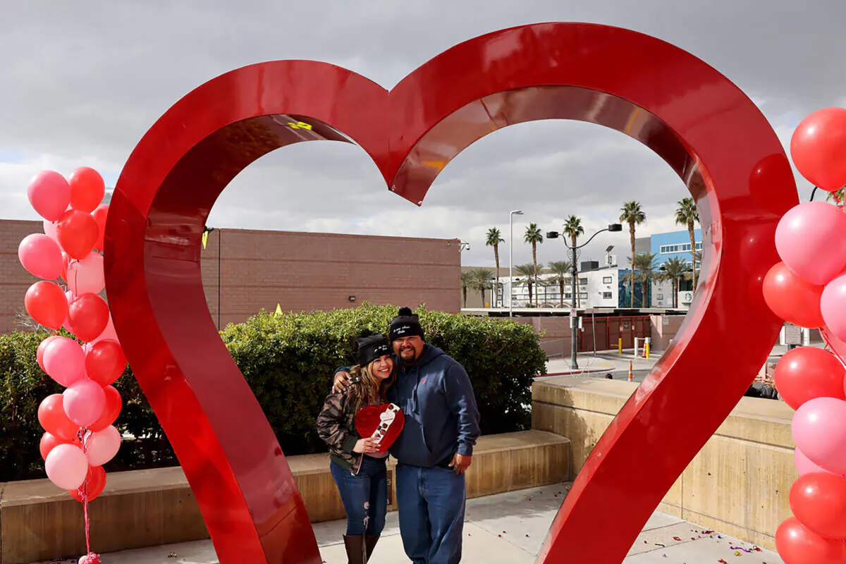 Wedding couple MarBella and Raul Moreno of San Diego are seen at the "Big Heart" sculpture outside the Clark County Marriage License Bureau in Las Vegas in February 2023. (K.M. Cannon/Las Vegas Review-Journal/TNS)