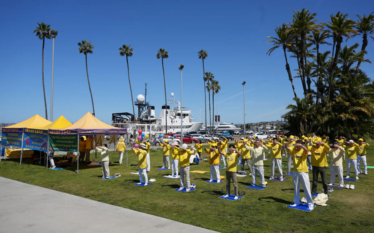 Members of the spiritual practice Falun Dafa demonstrate the practice's exercises as they celebrate World Falun Dafa Day at the San Diego County Administration building in Downtown San Diego on May 7, 2023. (Jane Yang/The Epoch Times)