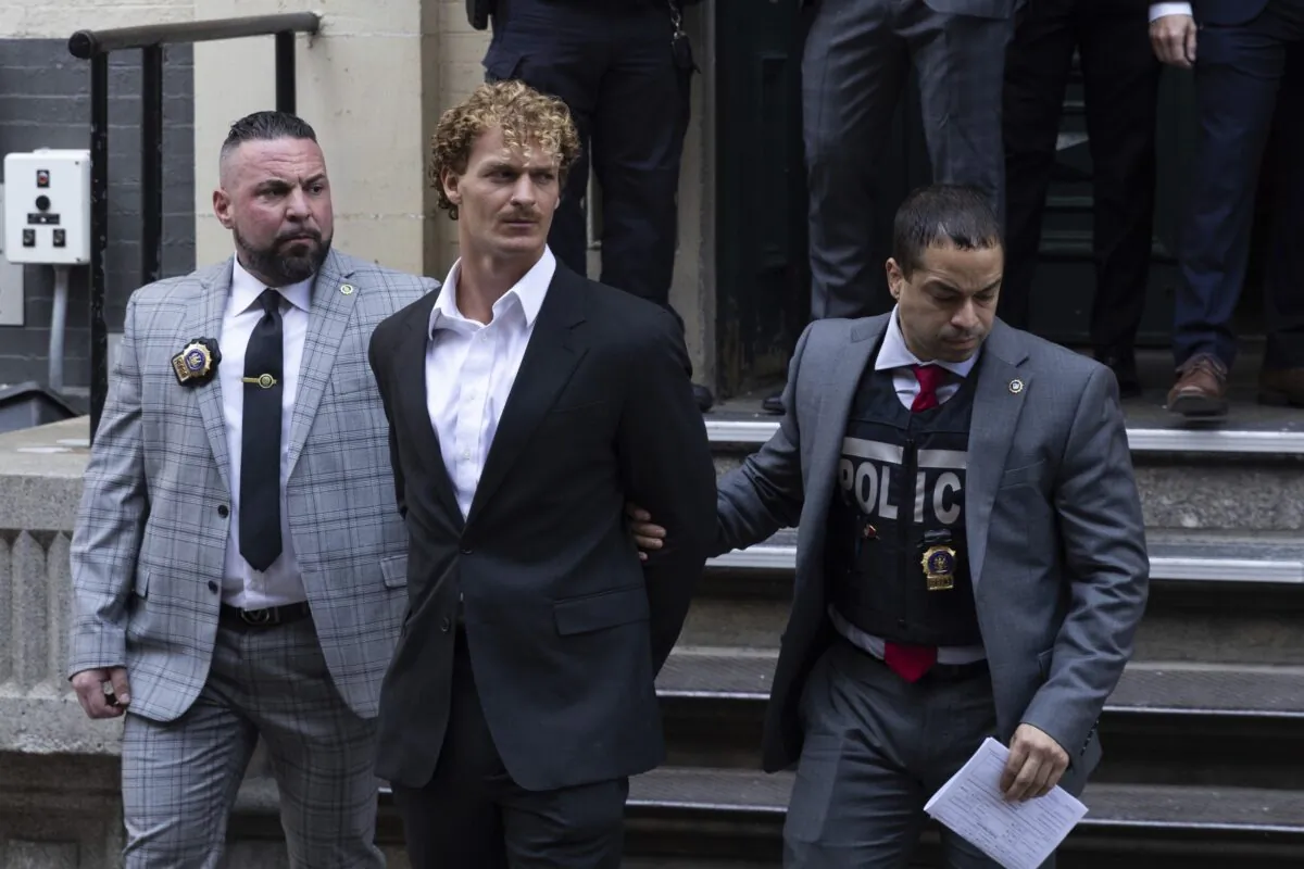 Daniel Penny (C) is walked by New York Police Department detectives detectives out of the 5th Precinct in New York on May 12, 2023. (Jeenah Moon/AP Photo)