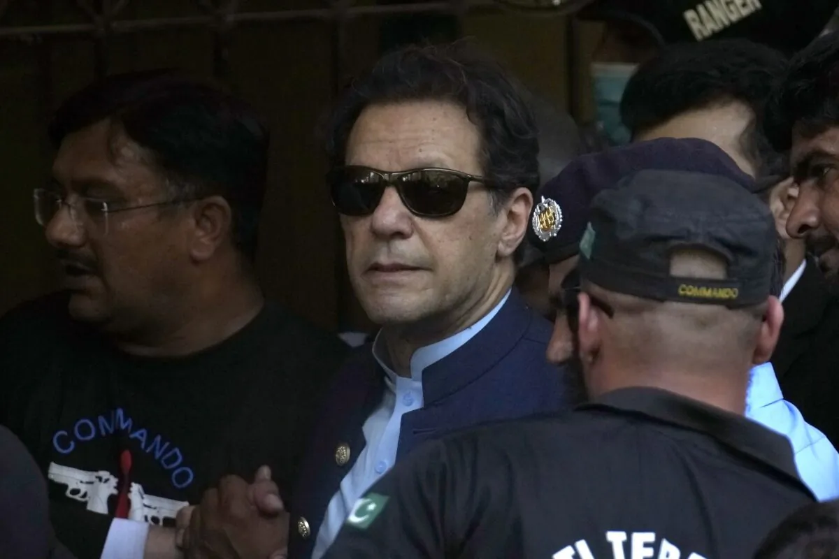 Pakistan's former Prime Minister Imran Khan (C) is escorted by security officials as he arrive to appear in a court, in Islamabad, Pakistan, on May 12, 2023. (Anjum Naveed/AP Photo)