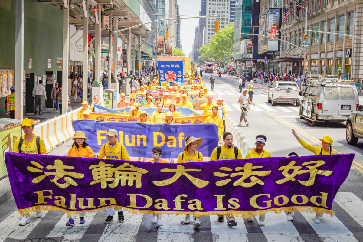 Falun Gong practitioners march in Manhattan to celebrate World Falun Dafa Day on May 12, 2023. (Larry Dye/The Epoch Times)