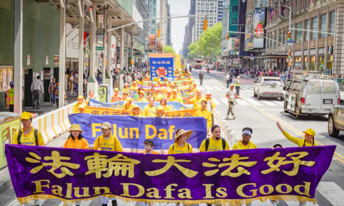 Falun Gong practitioners march in Manhattan to celebrate World Falun Dafa Day on May 12, 2023, in New York. (Larry Dye/The Epoch Times)