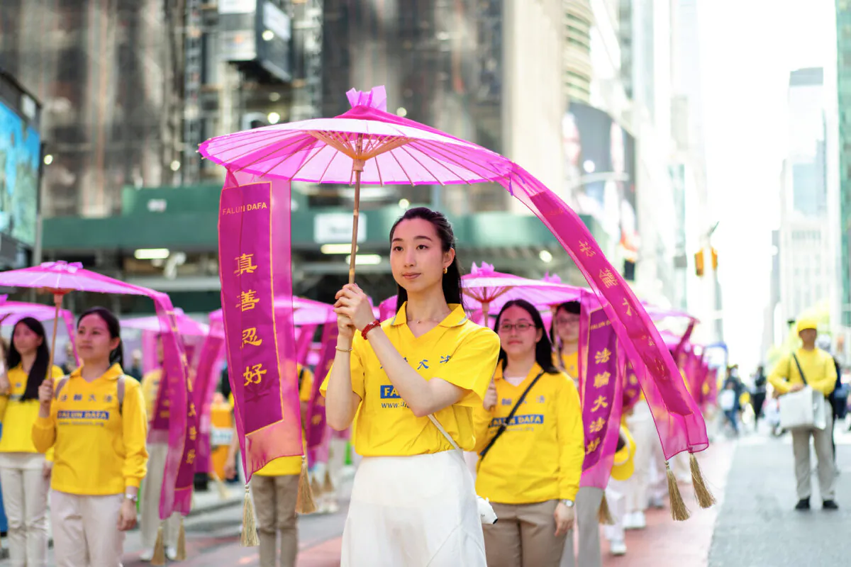 Falun Gong practitioners march in Manhattan to celebrate World Falun Dafa Day on May 12, 2023, in New York. (Samira Bouaou/The Epoch Times)