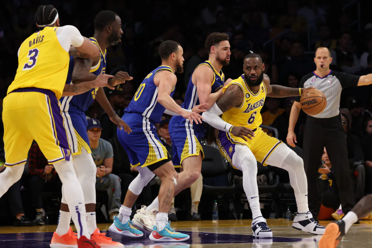 LeBron James (6) of the Los Angeles Lakers dribbles against Klay Thompson (11) and Stephen Curry (30) of the Golden State Warriors during the third quarter in game six of the Western Conference Semifinal Playoffs in Los Angeles on May 12, 2023. (Harry How/Getty Images)