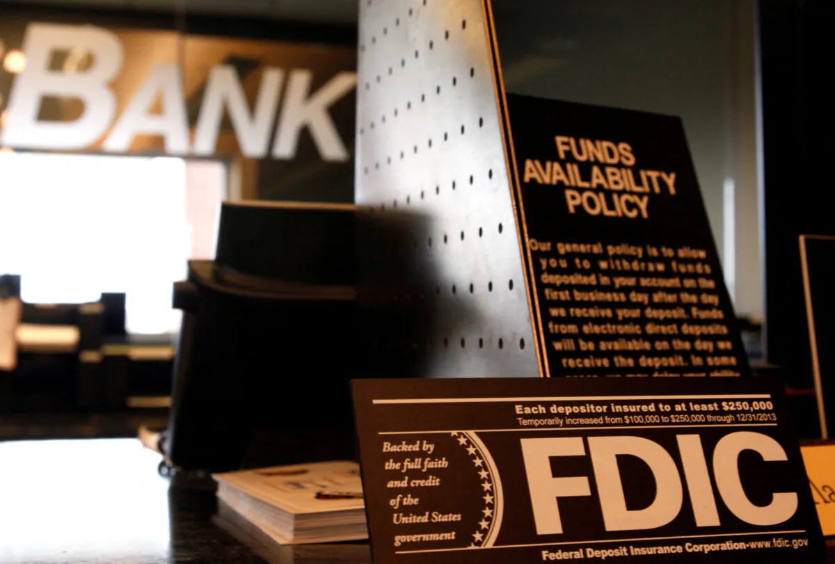Signs explaining Federal Deposit Insurance Corporation (FDIC) and other banking policies are shown on the counter of a bank in Westminster, Colo., Nov. 3, 2009. (Rick Wilking/Reuters/File Photo)