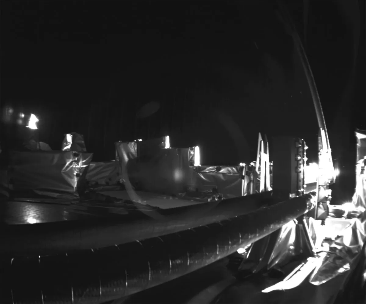 The second stuck part of the RIME antenna deploys, at right leaning vertically, on a spacecraft bound for Jupiter on May 12, 2023. (European Space Agency via AP)
