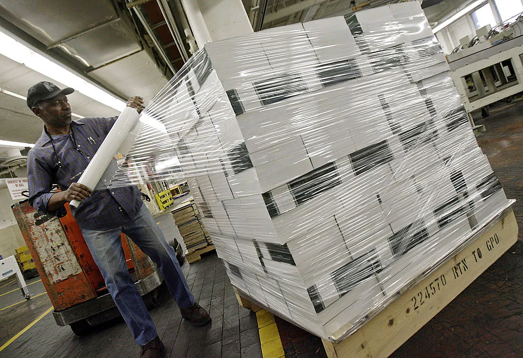U.S. Government Printing Office employee wraps plastic around a pallet of newly printed copies of the U.S. President George W. Bush Administration's budget for the 2008 fiscal year, February 1, 2007 in Washington, DC. (Chip Somodevilla/Getty Images)