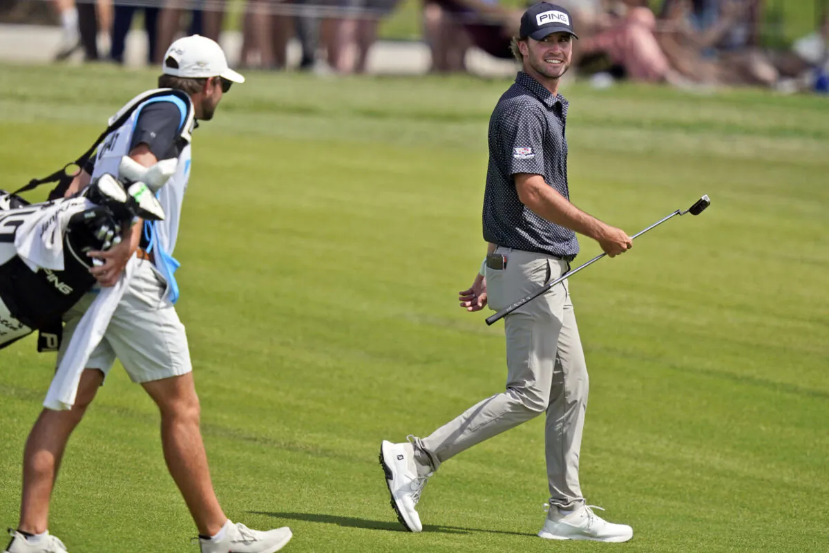 Austin Eckroat, right, smiles as he walks up the 18th hole during the third round of the Byron Nelson golf tournament in McKinney, Texas, on May 13, 2023. (LM Otero/AP Photo)