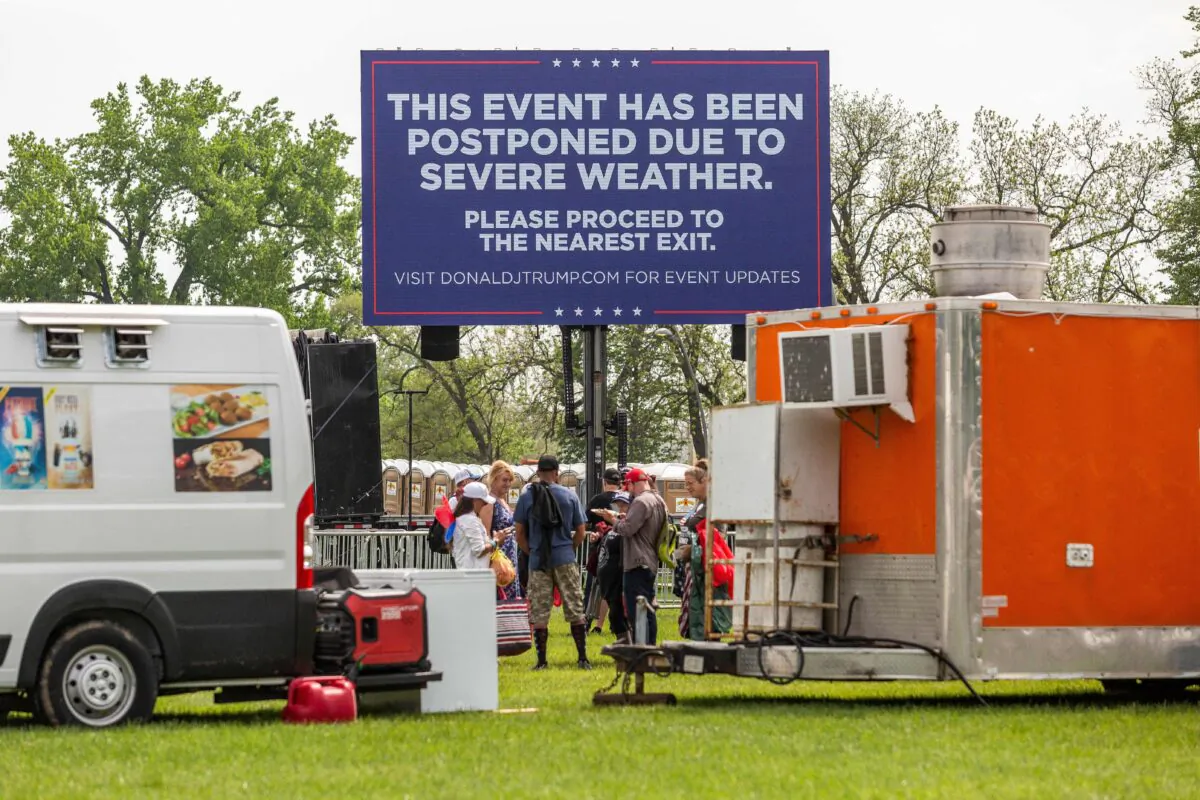 A sign that says former President Donald Trump's campaign event has been postponed due to severe weather, at Lauridsen Amphitheater at Water Works Park in Des Moines, Iowa, on May 13, 2023. (Rachel Mummey/AFP via Getty Images)