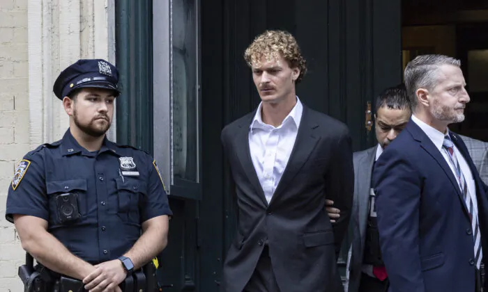 Daniel Penny (C) is walked by New York Police Department detectives detectives out of the 5th Precinct in New York on May 12, 2023. (Jeenah Moon/AP Photo)