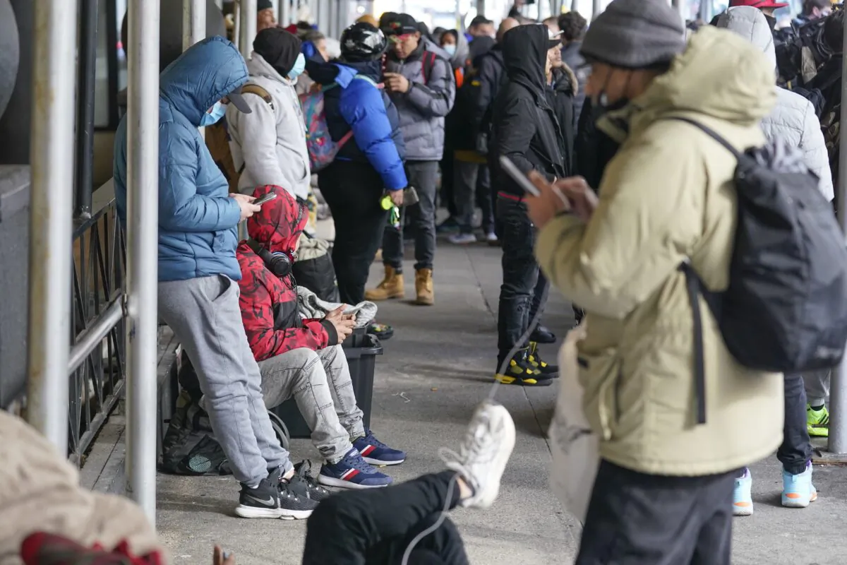 Illegal immigrants with their belongings on the sidewalk in front of the Watson Hotel in New York on Jan. 30, 2023. (Seth Wenig/AP Photo)