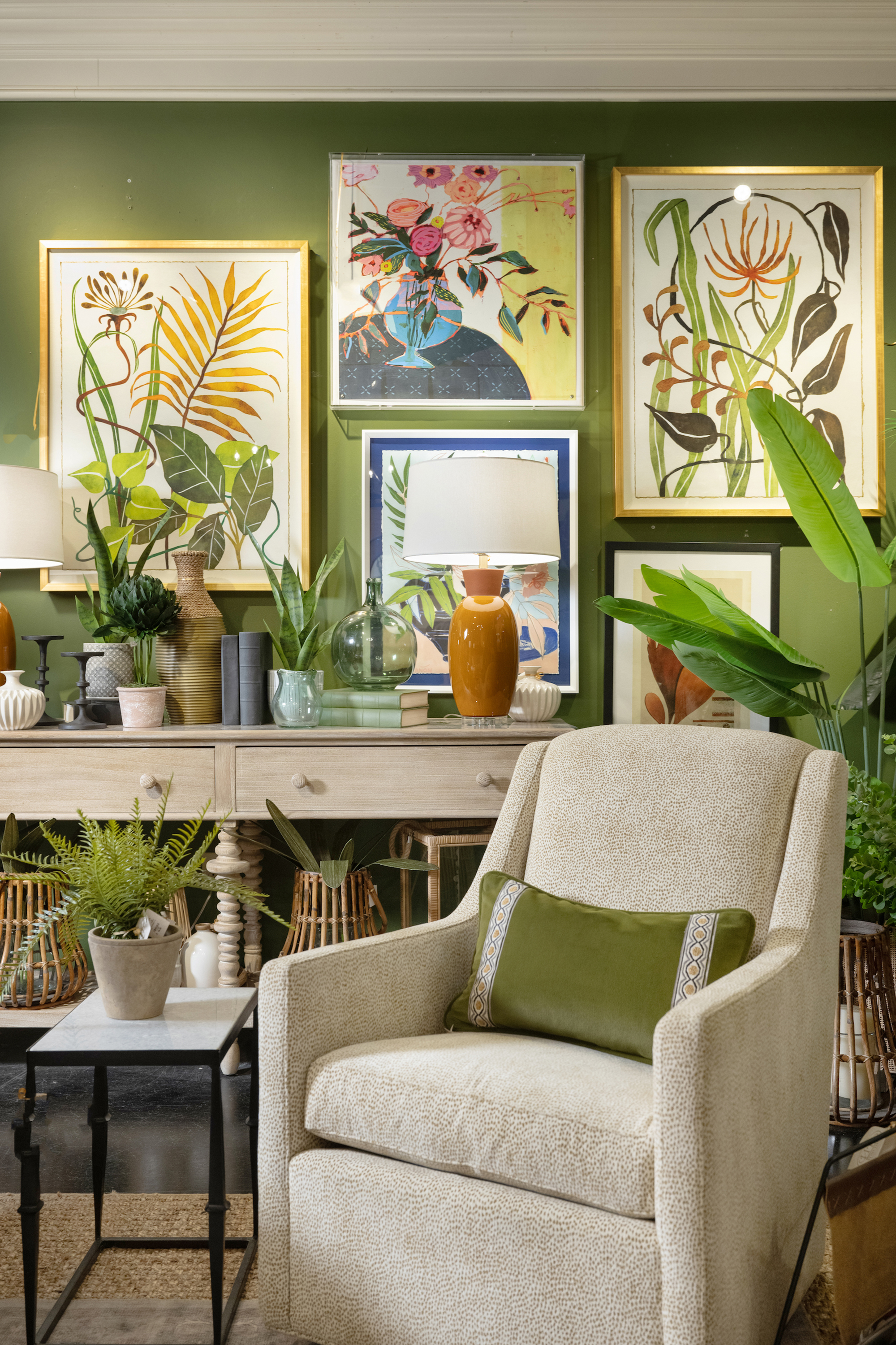 A green livingroom with botanical artwork
