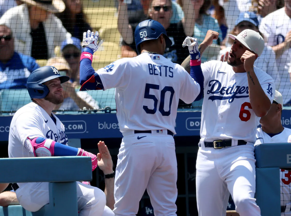 Mookie Betts (50) of the Los Angeles Dodgers celebrates his two run homerun with David Peralta (6) and Max Muncy (13), to take a 2—0 lead over the San Diego Padres, during the third inning at Dodger Stadium in Los Angeles on May 14, 2023. (Harry How/Getty Images)