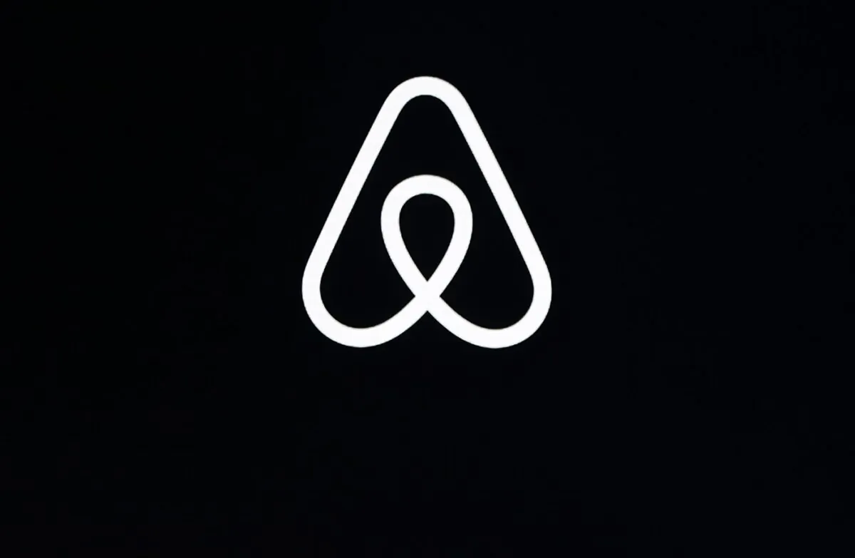 This Feb. 22, 2018, file photo, shows an Airbnb logo during an event in San Francisco. (The Associated Press/Eric Risberg)