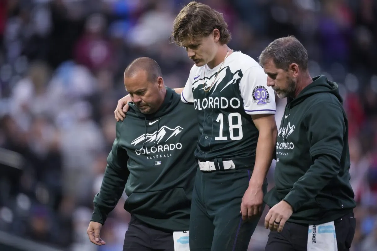 Trainers lead Colorado Rockies starting pitcher Ryan Feltner off the field after he was struck by a batted ball during the second inning of the team's baseball game against the Philadelphia Phillies in Denver on May 13, 2023. (David Zalubowski/AP Photo)