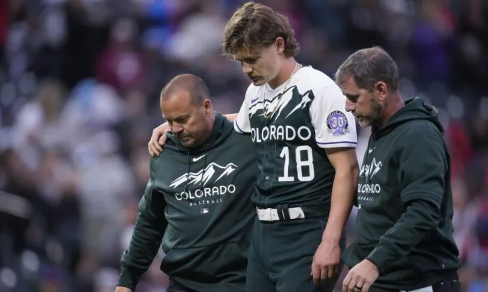 Trainers lead Colorado Rockies starting pitcher Ryan Feltner off the field after he was struck by a batted ball during the second inning of the team's baseball game against the Philadelphia Phillies in Denver on May 13, 2023. (David Zalubowski/AP Photo)
