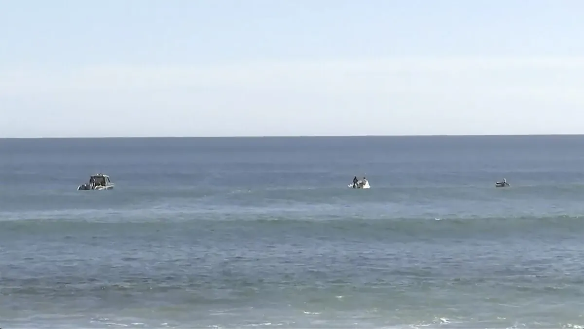 Searchers on boats conduct an operation in waters in Elliston, Australia, on May 13, 2023, in a still from video. (Australian Broadcasting Corp. via AP)