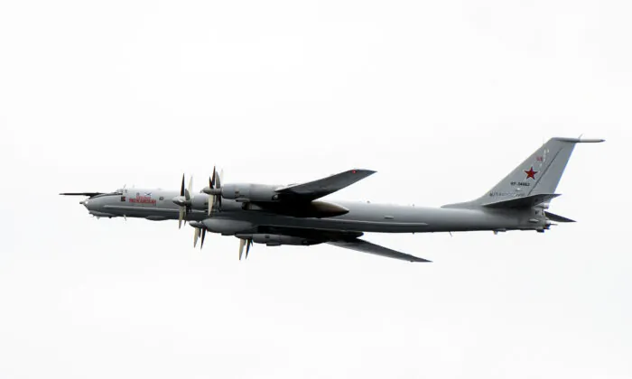A Russian Tupolev TU-142 flies by the USS Mount Whitney of the U.S. Navy during the NATO-led military exercise Trident Juncture at the Norwegian sea outside Trondheim, Norway, on Nov. 2, 2018. (Jonathan Nackstrand/AFP via Getty Images)