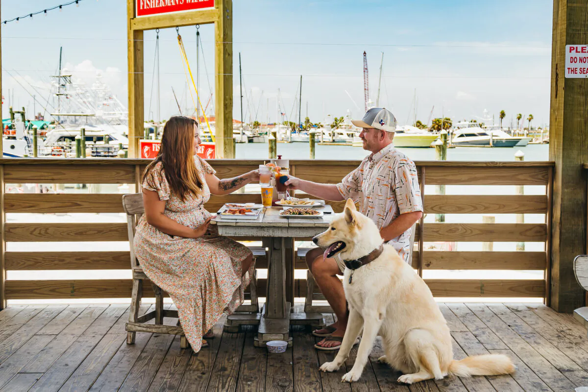 Guests, including the 4-footed variety, dine at Grumbles Seafood Co. in Port Aransas, Texas. (Courtesy Port Aransas Tourism Bureau/TNS)