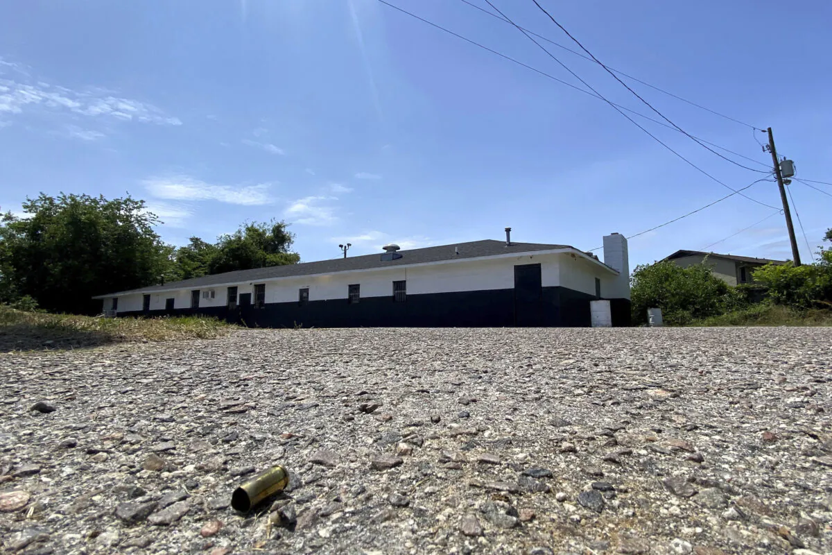 A spent shell casing from a gun lies on the pavement on May 15, 2023, outside a motorcycle club's clubhouse building in Augusta, Ga., where authorities say a shootout took place that killed a few people and injured others. (Katie Goodale/The Augusta Chronicle via AP)