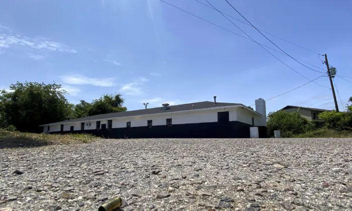 A spent shell casing from a gun lies on the pavement on May 15, 2023, outside a motorcycle club's clubhouse building in Augusta, Ga., where authorities say a shootout took place that killed a few people and injured others. (Katie Goodale/The Augusta Chronicle via AP)