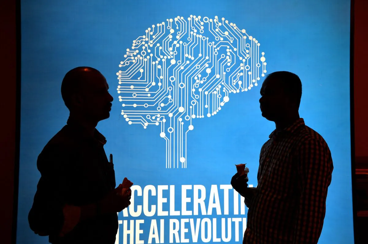 Participants at Intel's Artificial Intelligence (AI) Day stand in front of a poster during the event in the Indian city of Bangalore on April 4, 2017. (Manjunath Kiran/AFP via Getty Images)