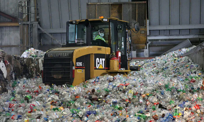 A tractor drives through a giant pile of plastic bottles at the San Francisco Recycling Center April 22, 2008. (Justin Sullivan/Getty Images)