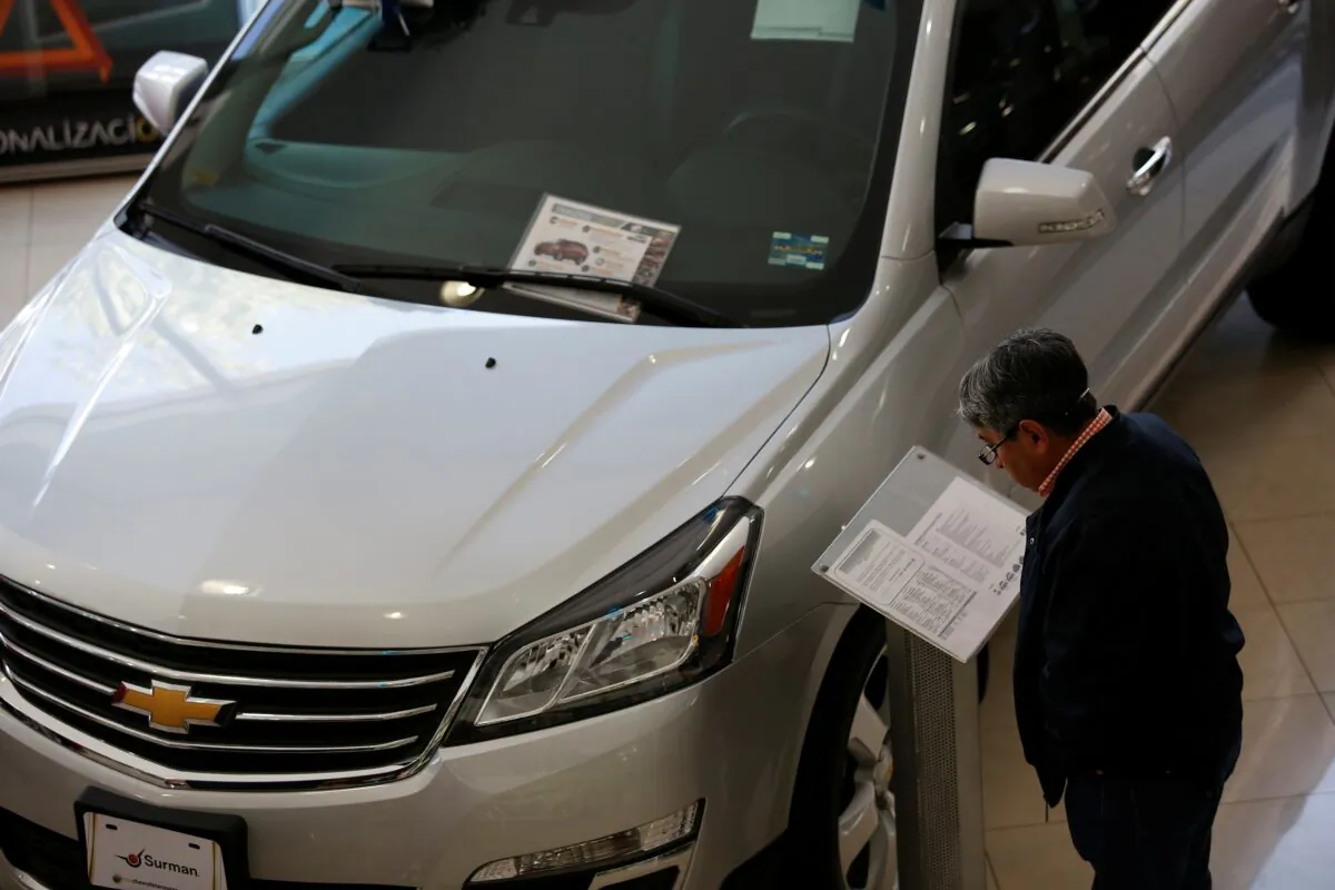 A customer checks out details of a Chevrolet Traverse being displayed at Surman Chevrolet car dealership in Mexico City on Jan. 9, 2018. (Ginnette Riquelme/Reuters)