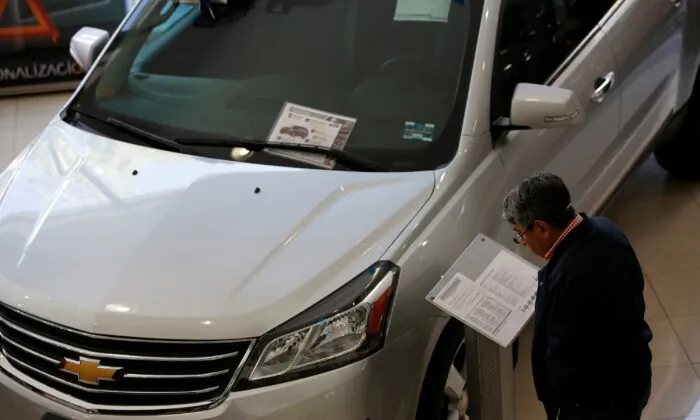 A customer checks out details of a Chevrolet Traverse being displayed at Surman Chevrolet car dealership in Mexico City on Jan. 9, 2018. (Ginnette Riquelme/Reuters)