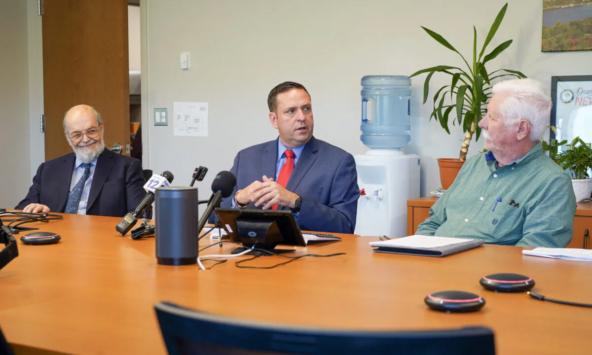 Developer Neil Gold (L), County Executive Steve Neuhaus, and Montgomery Supervisor Ronald Feller unveiled a new site for a future dinosaur park at a press conference in Goshen, N.Y., on May 15, 2023. (Cara Ding/The Epoch Times)