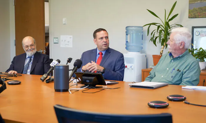 Developer Neil Gold (L), County Executive Steve Neuhaus, and Montgomery Supervisor Ronald Feller unveiled a new site for a future dinosaur park at a press conference in Goshen, N.Y., on May 15, 2023. (Cara Ding/The Epoch Times)