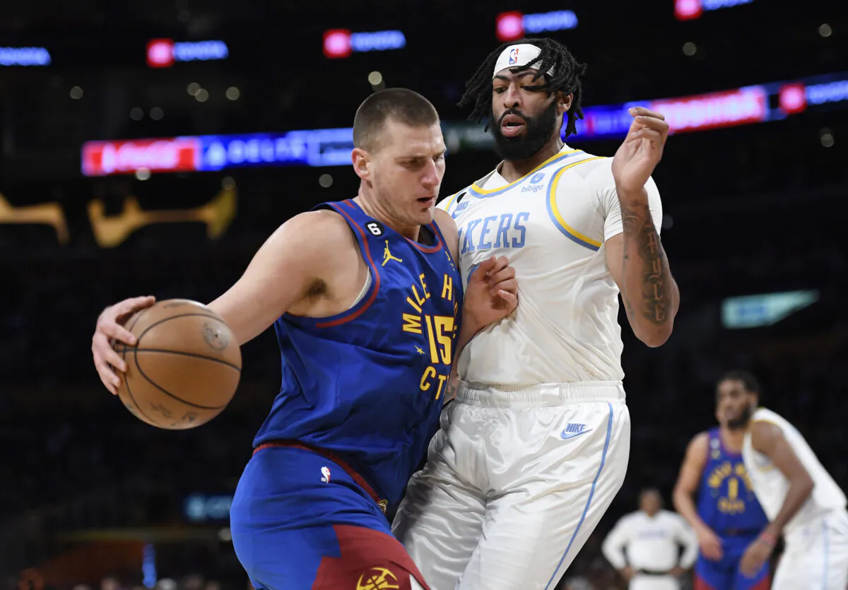 Nikola Jokic (15) of the Denver Nuggets pushes against Anthony Davis (3) of the Los Angeles Lakers during the first half in Los Angeles on Oct. 30, 2022. (Kevork Djansezian/Getty Images)