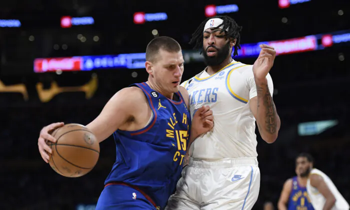 Nikola Jokic (15) of the Denver Nuggets pushes against Anthony Davis (3) of the Los Angeles Lakers during the first half in Los Angeles on Oct. 30, 2022. (Kevork Djansezian/Getty Images)